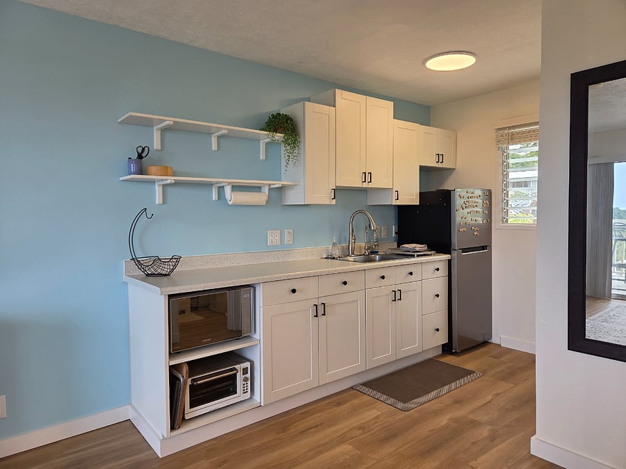 Well appointed and functional kitchenette with an apartment sized fridge, microwave, toaster oven, pots, pants, plateware and cutlery.

The dual burner professional grade infrared cook top stores easily into the top drawer for a clutter free work space when not in use. 