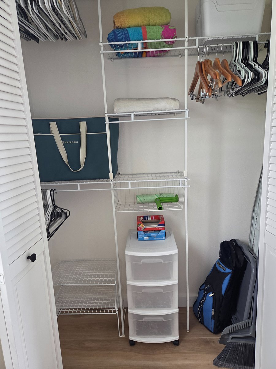 Full sized closet with hanging and shelf space opposite the kitchenette. 