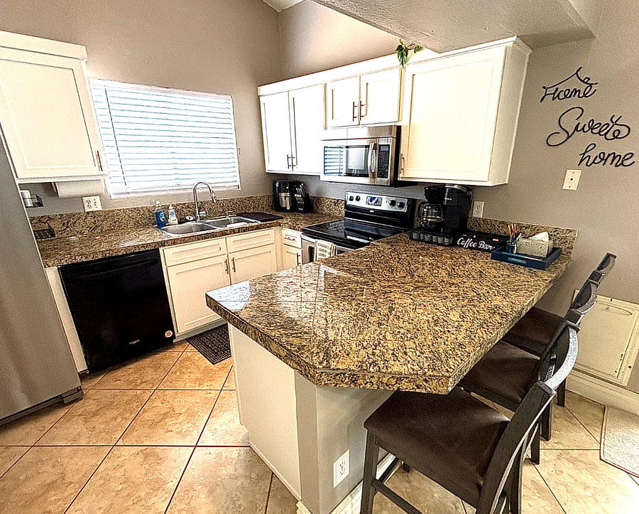 A fully equipped kitchen and breakfast | coffee bar makes everyday living feel easy.