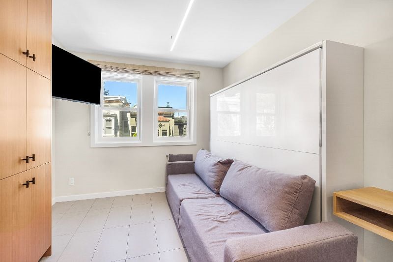Queen Murphy bed over sofa and wall-mounted flat screen TV