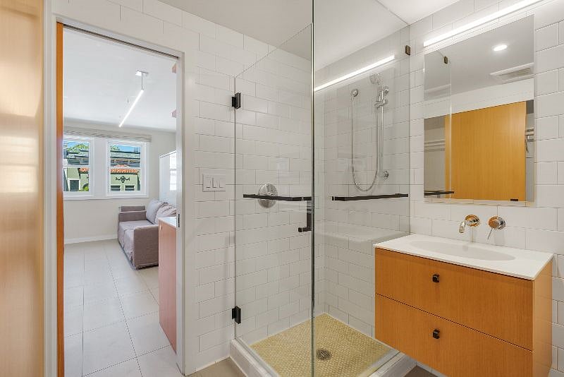 Glass walled shower and view back into living soace