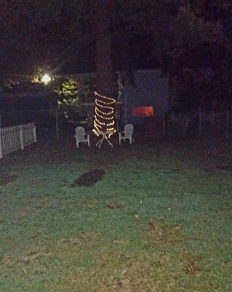 The back yard with solar lights for ambience and chairs to relax!