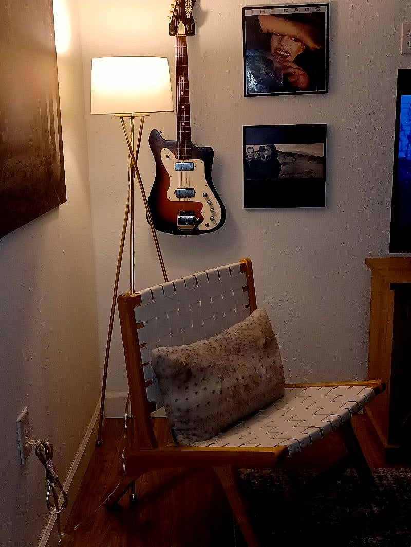 I love this old school electric guitar and framed records from the 80's!