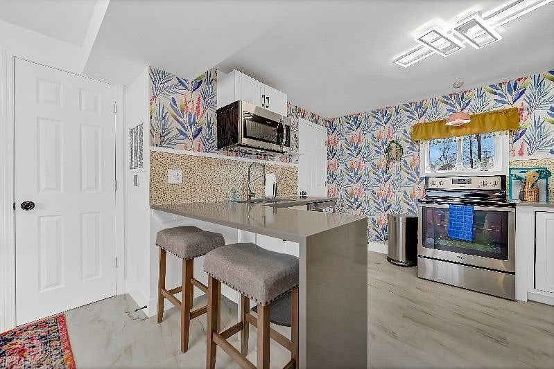 Kitchen with a quartz waterfall countertop