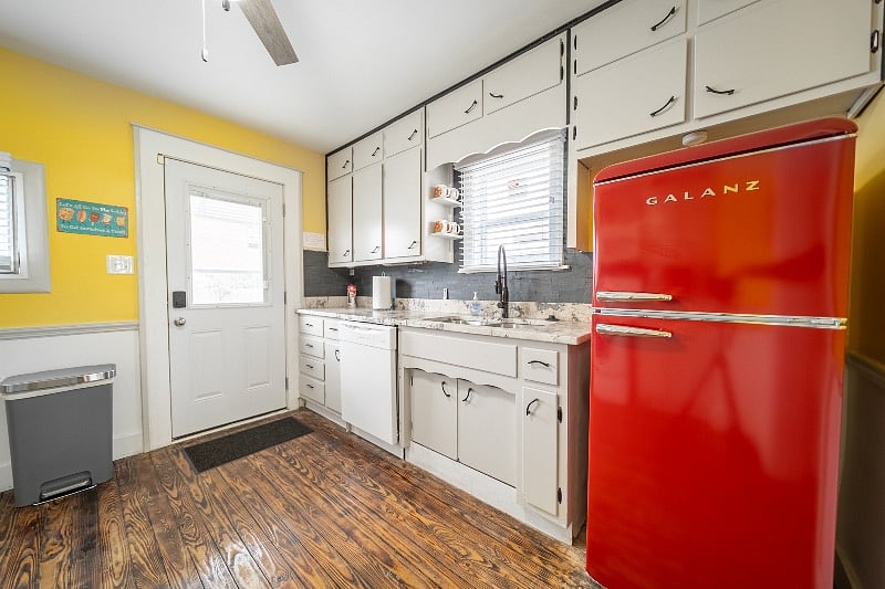 The kitchen opens up to the fully fenced in backyard.