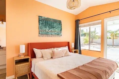 Primary bedroom with King mattress, smart tv, en room bathroom suite with dual sink and walk in shower