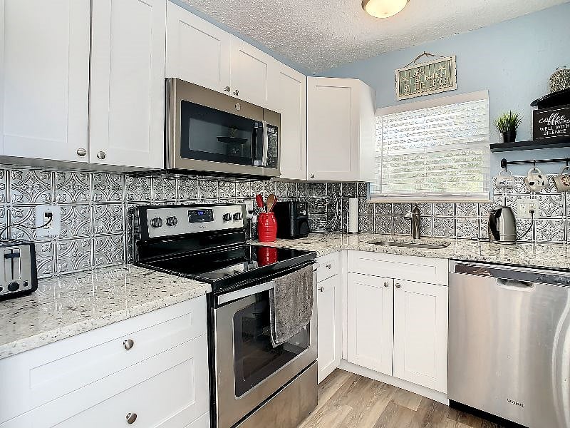 Updated backsplash, cabinetry and granite countertops