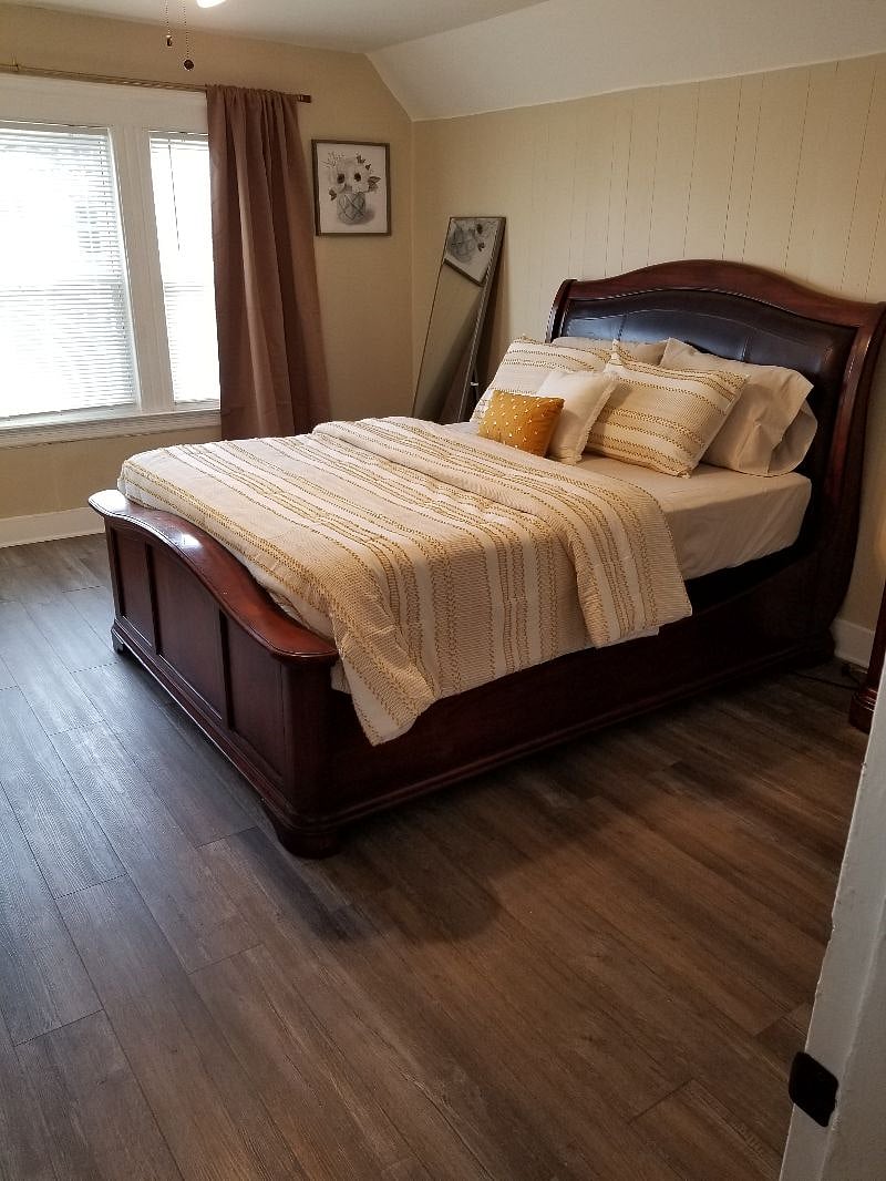 Bedroom #1 queen size bed, dresser, tv stand, 1 side table, closet, ceiling fan, blackout curtains.