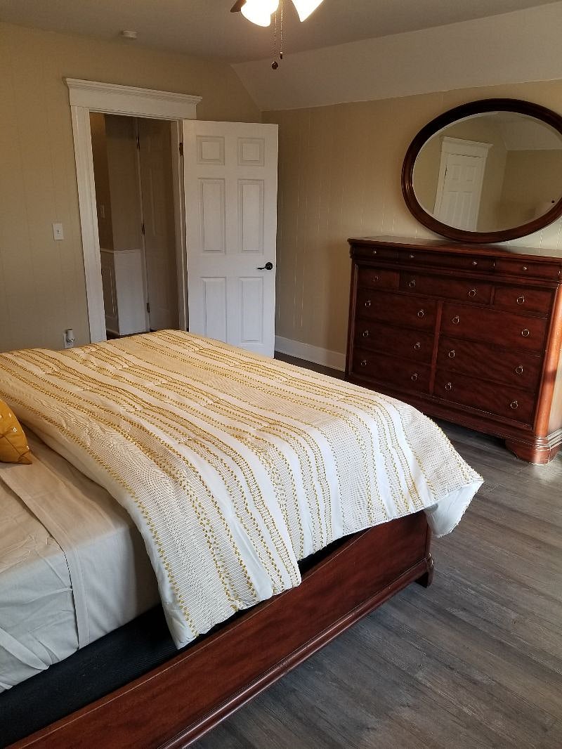 Bedroom #1, queen size bed, dresser, tv stand, 1 side table, closet, ceiling fan, blackout curtains.