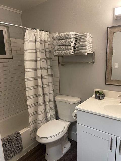 bathroom shower area, towel rack above toilet