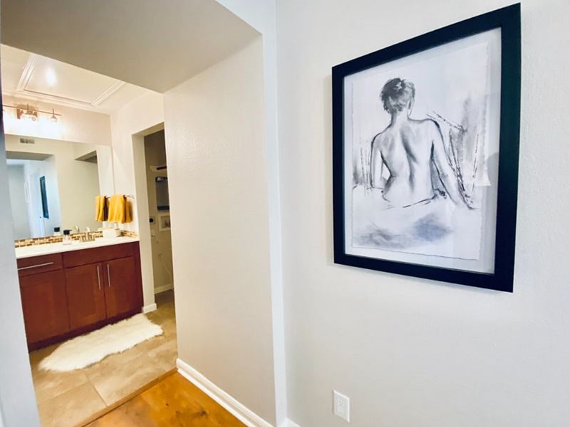Bedroom with view into bathroom and laundry
