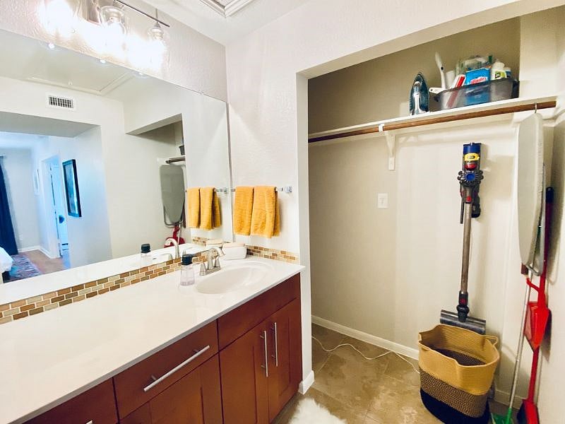 Bathroom vanity with plenty of storage, and laundry