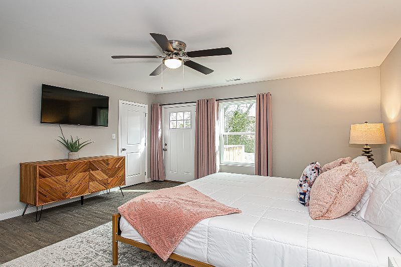 Primary bedroom, access to back deck & fenced in backyard