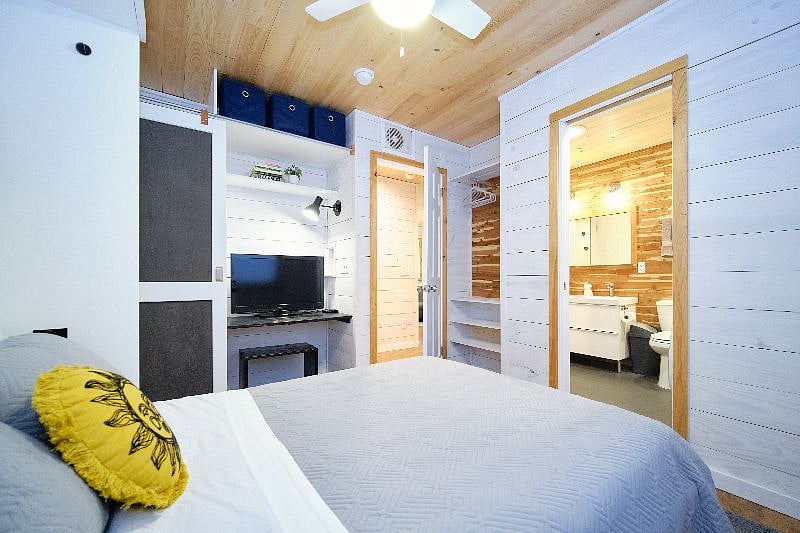 Second bedroom has additional storage space behind door. It connects to the bathroom with a pocket door.