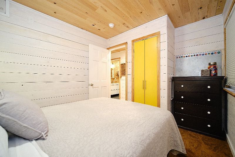 Closet and dresser in main bedroom with queen bed.