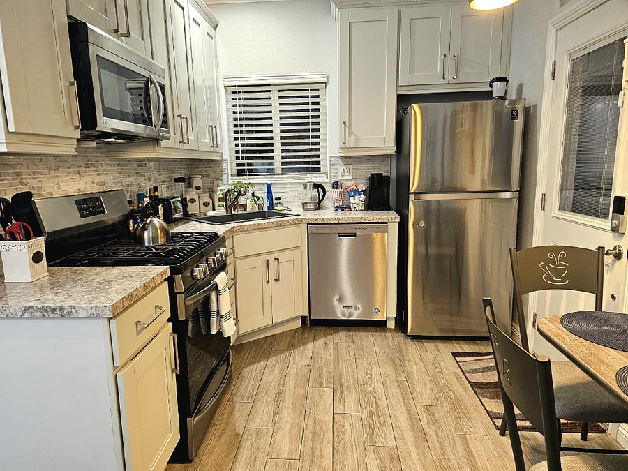 Full kitchen and stocked with samples of many drinking and cooking provisions