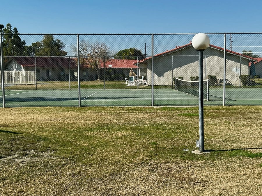 Tennis court across the greenway from our patio.
Note: grass is greener most of the year;not so green in winter months.