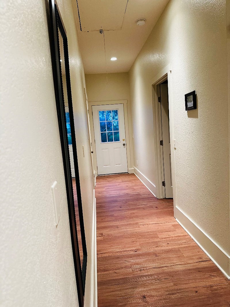 Hallway leading to master bedroom on the right. Straight ahead is access to outside.
Straight ahead before the door outside, is access to laundry room, exercise, recreation room.
