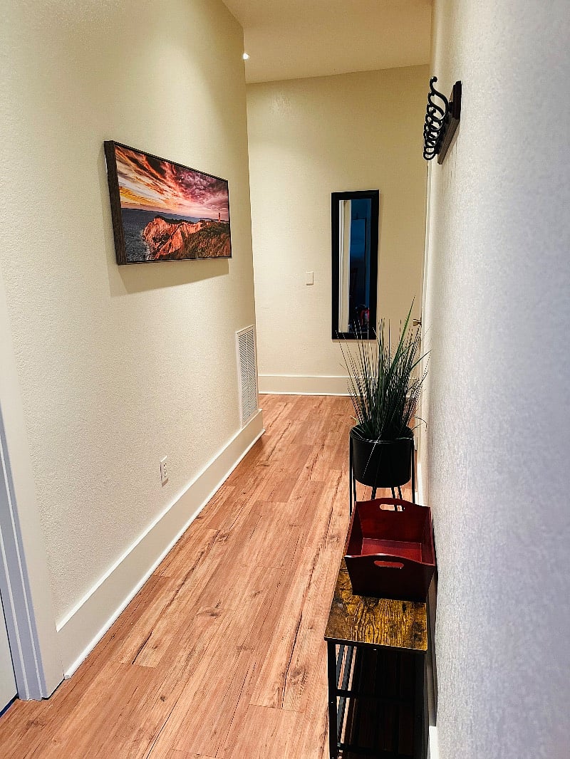 Hallway from main living leading to bedrooms, bathroom, laundry area.