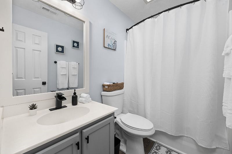 Spacious guest bathroom with a bathtub and shower