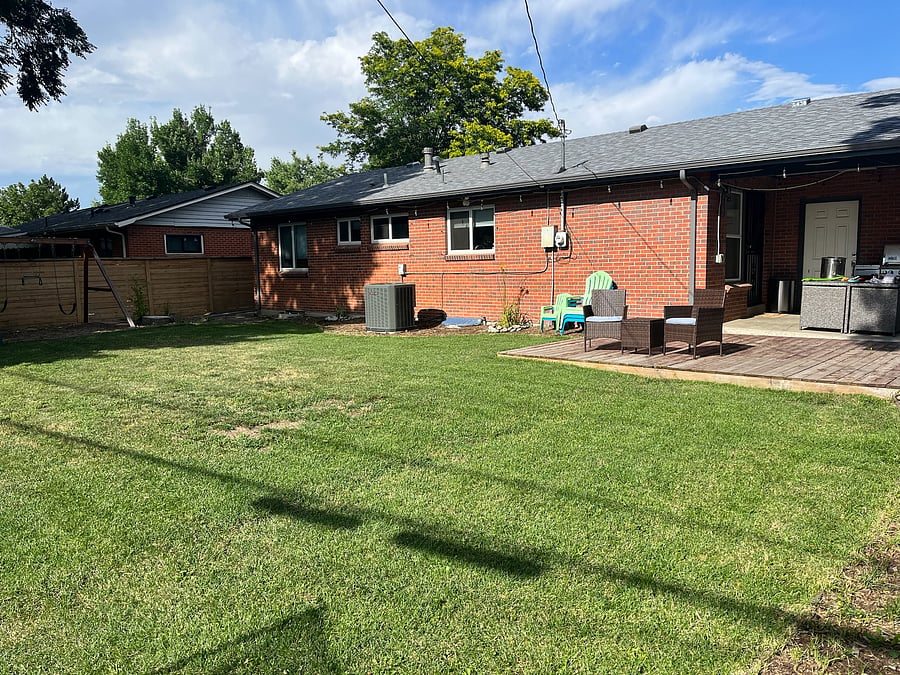 Denver is currently experiencing a drought and water restrictions. Therefore, the yard is yellow and dry but we hope it back to lush and green grass soon!