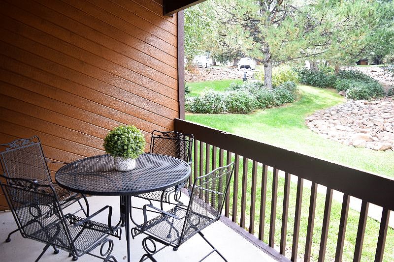 Patio balcony dining with BBQ for grilling.