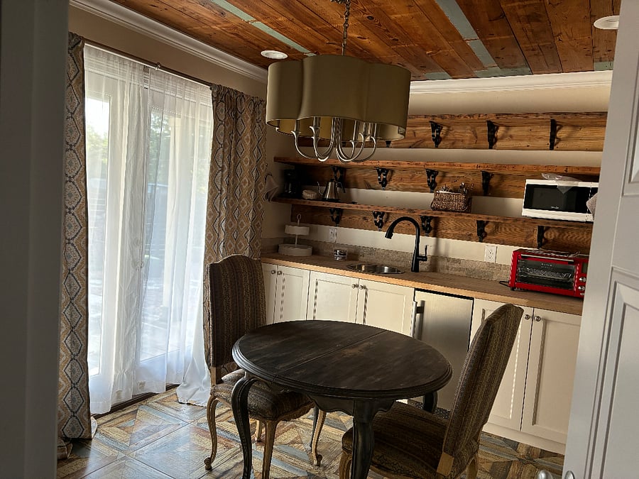 Fully furnished kitchenette with French doors out to the deck 
