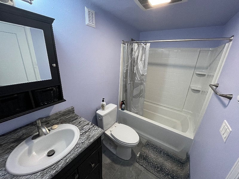 Bathroom with new granite counter and bath/shower