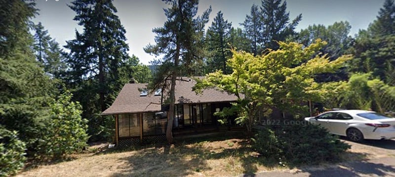 View of the house from the street. Well-lit stairs to the right of the garage lead directly to the guest apartment.