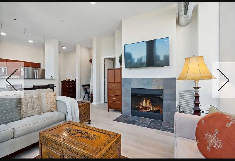 Living room with HDTV, slate fireplace & hardwood floors