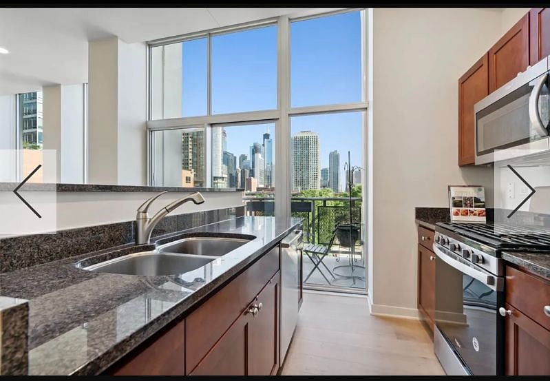 Fully stocked kitchen with modern appliances & skyline views