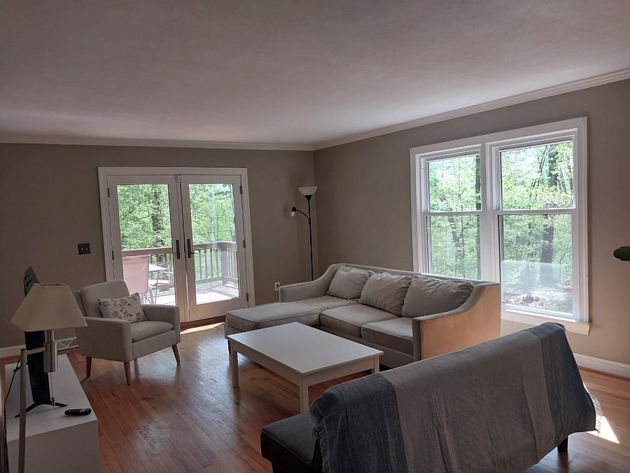 This living room leads to the back deck that has a nice view of the forest.