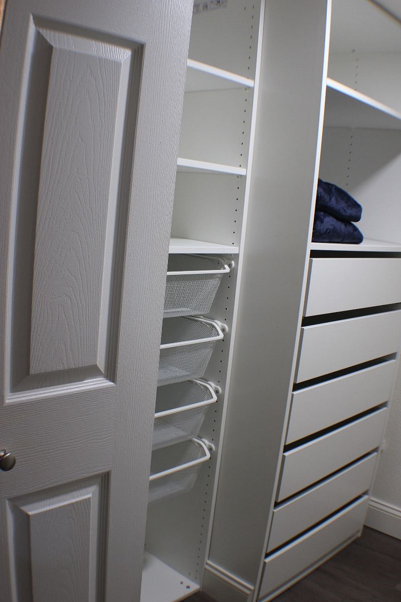 Bedroom closet with baskets and drawers on opposite side, not pictured is a hanging rod with hangers 