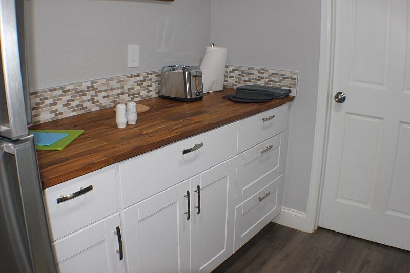 Teak counter with designer backsplash, toaster and papertowel dispenser