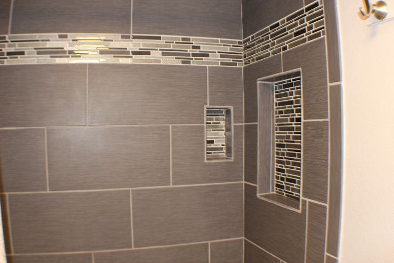 Bathroom showing built in cubbies for shampoo
