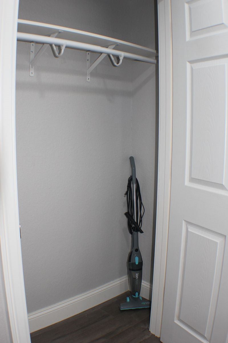 Large closet in Livingroom with vacuum and stepstool