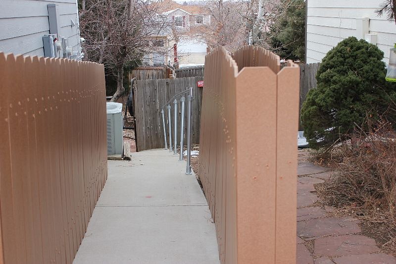 View from top of drive down to gate then apartment
