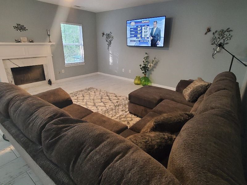 Family room with cozy sectional with wall mounted Smart TV 