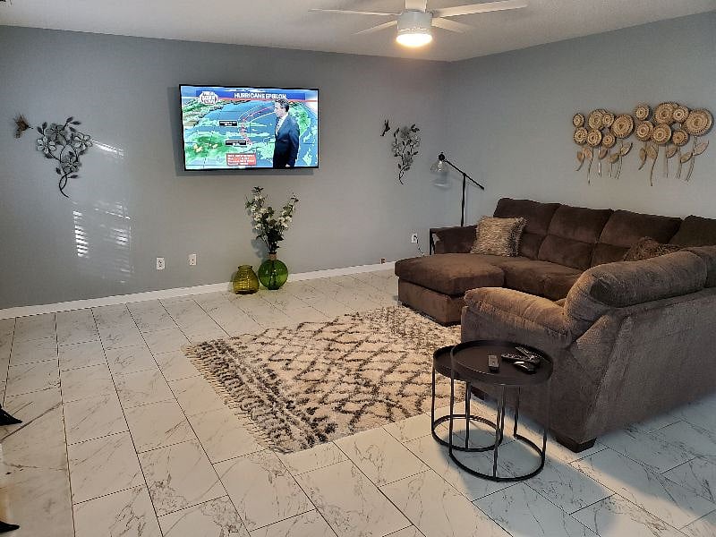 Family Room with cozy sectional with wall mounted Smart TV 