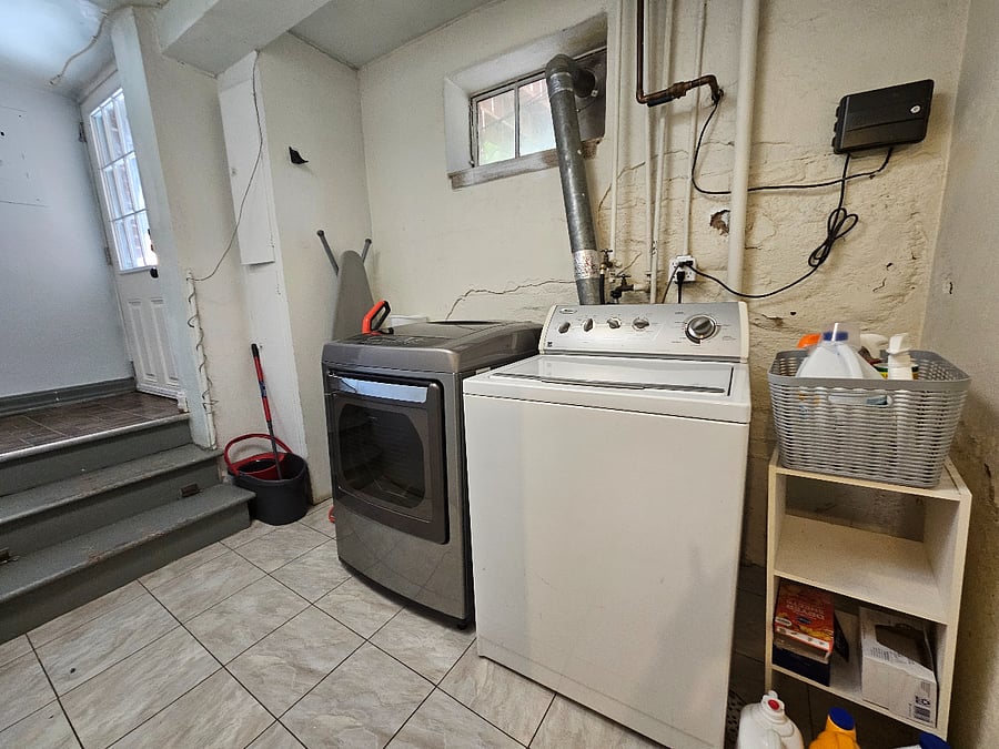 Shared laundry area downstairs between units.