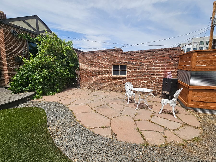 Private 8' fenced & gated backyard. Kitchen has sliding glass patio door with small sitting area and stairs to backyard. (Add'l Garden Level unit of the duplex has their own private yard.)