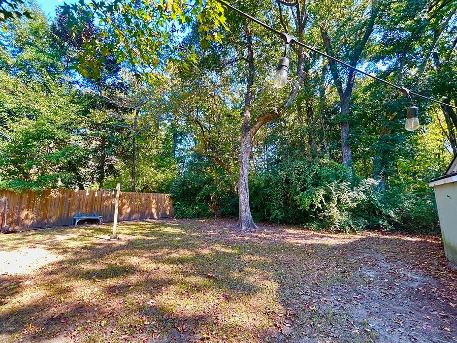 Yard fenced on 3 sides and backs to woods.... with Fire pit!