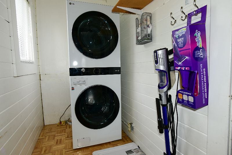 This is a single unit stacked washer/dryer. Also supplied is broom, mop and vacuum.