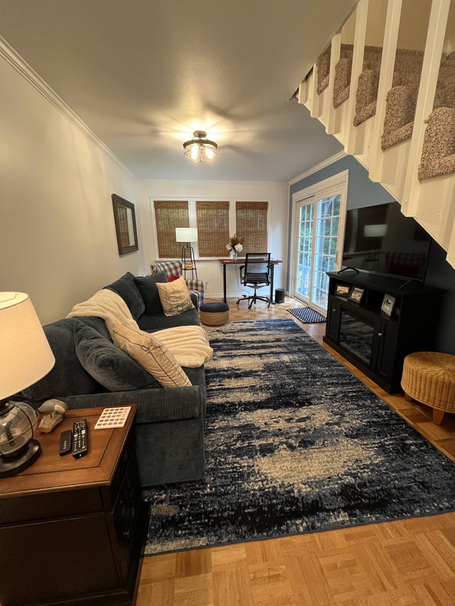 Living area with adjustable work desk and chair and electric fireplace