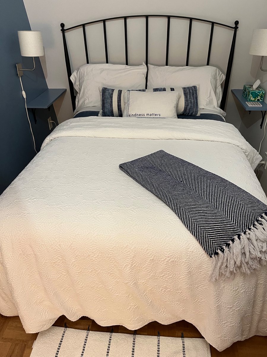 Full size bed with a variety of pillows and blankets for personalized comfort