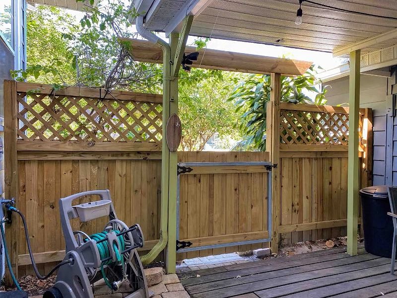 Inside back (entry) gate to garden. Ring toss, hose reel, overflow garbage bin.