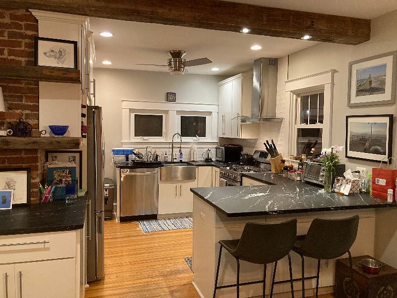 Exposed brick and wooden beams - beautiful shared kitchen