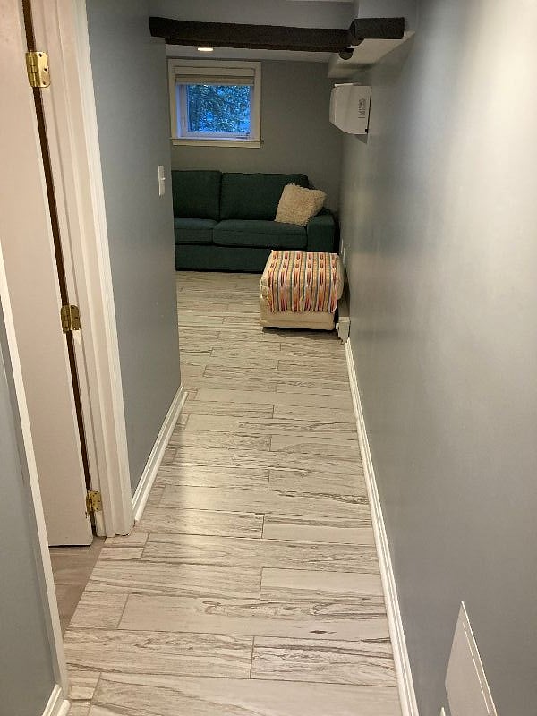 Hallway with bathroom on left