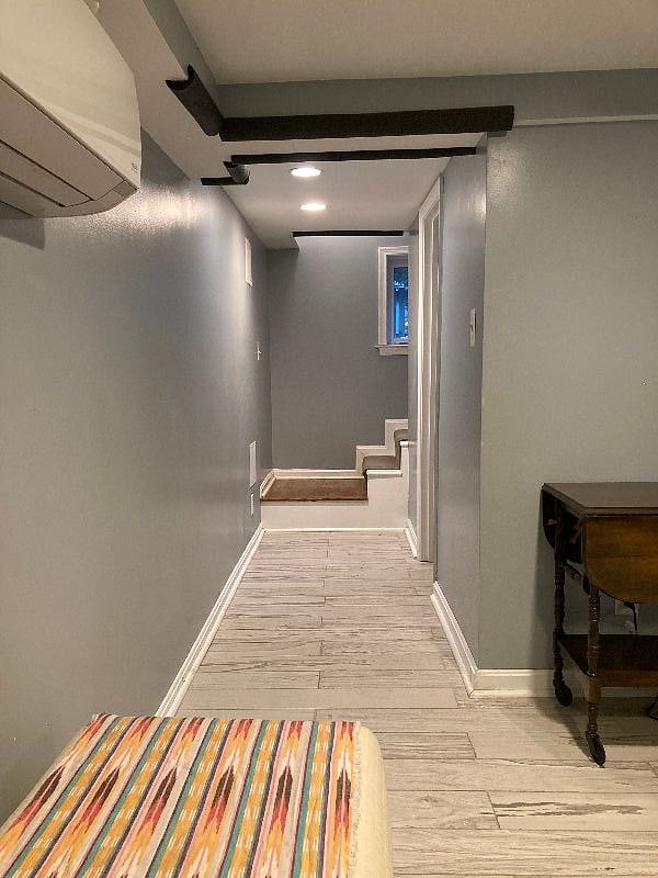 Hallway with bathroom on right