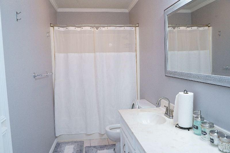 Hallway Bathroom With Double Sinks And Full Bath Tub For Relaxing Bubble Baths